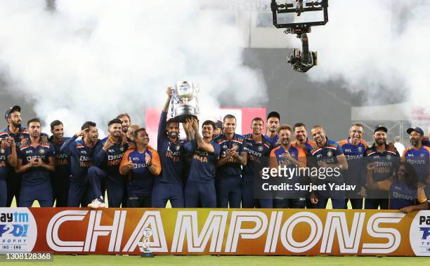 Suryakumar Yadav and Ishan Kishan of India lift the trophy with teammates after winning the 5th T20 International between India and England at...