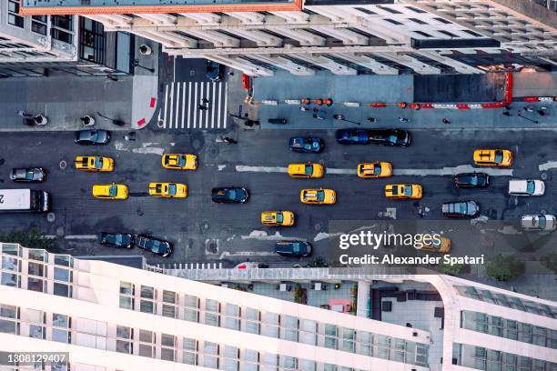 aerial view of taxi cars driving on fifth avenue, new york city, usa - yellow taxi stock pictures, royalty-free photos & images