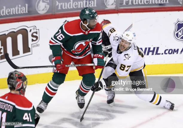 Subban of the New Jersey Devils battles with Sidney Crosby of the Pittsburgh Penguins during the second period at the Prudential Center on March 20,...