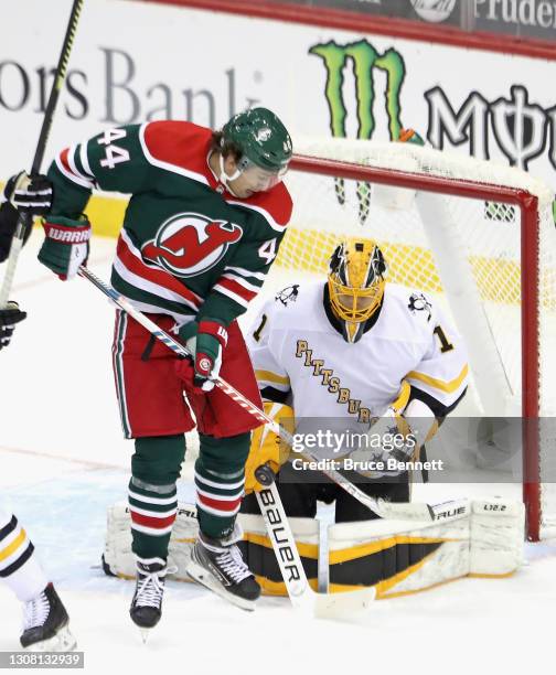 Casey DeSmith of the Pittsburgh Penguins makes the second period save as Miles Wood of the New Jersey Devils screens him at the Prudential Center on...