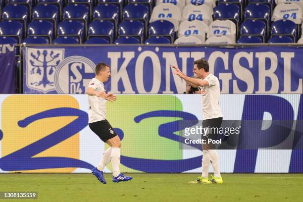 Stefan Lainer of Borussia Moenchengladbach celebrates with Jonas Hofmann after scoring their team's second goal during the Bundesliga match between...