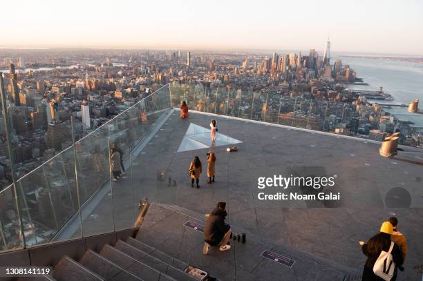 People watch the sunrise from the Edge observation deck at Hudson Yards on the first day of spring on March 20, 2021 in New York City.