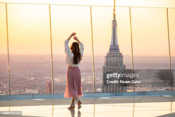 Person watches the sunrise from the Edge observation deck at Hudson Yards on the first day of spring on March 20, 2021 in New York City.