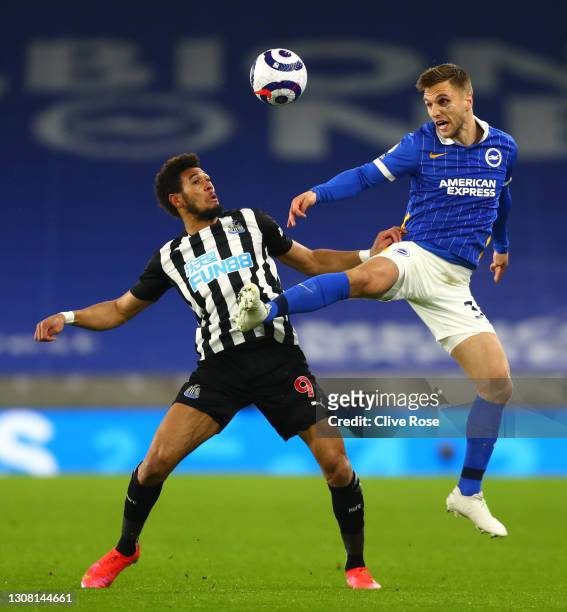 Joel Veltman of Brighton & Hove Albion battles for possession with Joelinton of Newcastle United during the Premier League match between Brighton &...