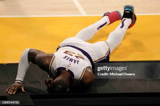 LeBron James of the Los Angeles Lakers reacts to an apparent injury during the second period of a game against the Atlanta Hawks at Staples Center on...