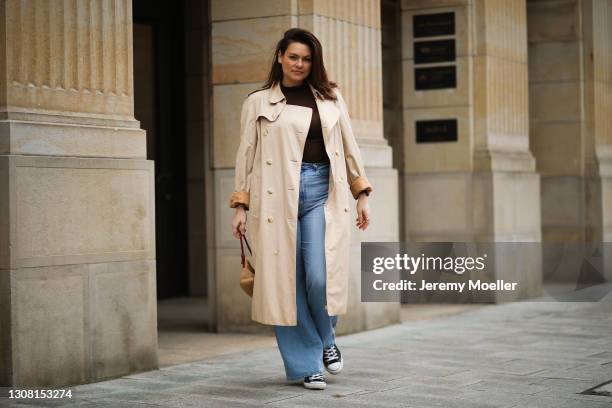 Dayami Candebat wearing brown Uniqlo turtleneck, Levis flared jeans, beige vintage Burberry trenchcoat, Converse sneaker and brown Fendi Raffia...