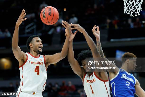 Evan Mobley and Chevez Goodwin of the USC Trojans compete for a rebound during the second half against the Drake Bulldogs in the first round game of...