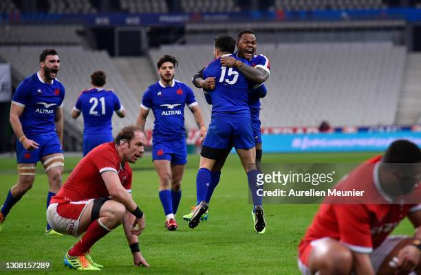 Brice Dulin of France celebrates scoring his sides 4th and winning try with Virimi Vakatawa as Alun Wyn Jones of Wales looks on dejected during the...