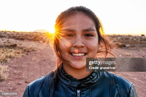 a close up portrait of a navajo native american young woman near her home in monument valley, utah - minority groups stock pictures, royalty-free photos & images