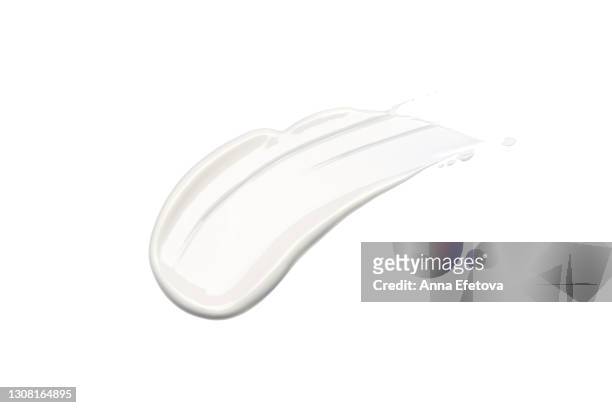 white cosmetics smear on isolated white background. perfect swatch for advertising and packaging. from above. flat lay style - creme stock-fotos und bilder