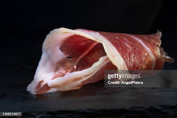 a piece of iberian ham - a still life of one of the best apreciated taste of the spaniish food. - presunto imagens e fotografias de stock