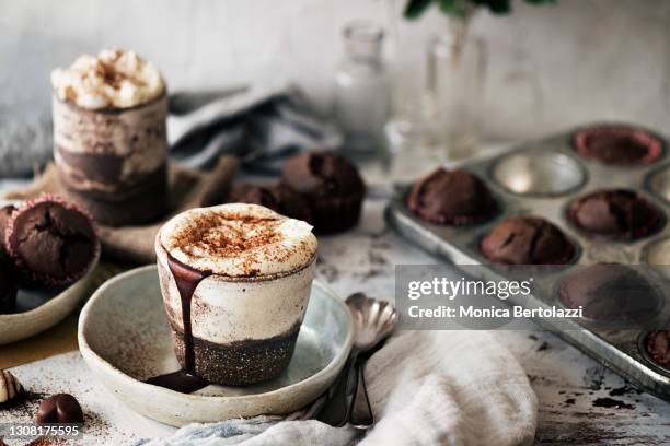 hot chocolate and muffins on rustic table - hot chocolate stock-fotos und bilder