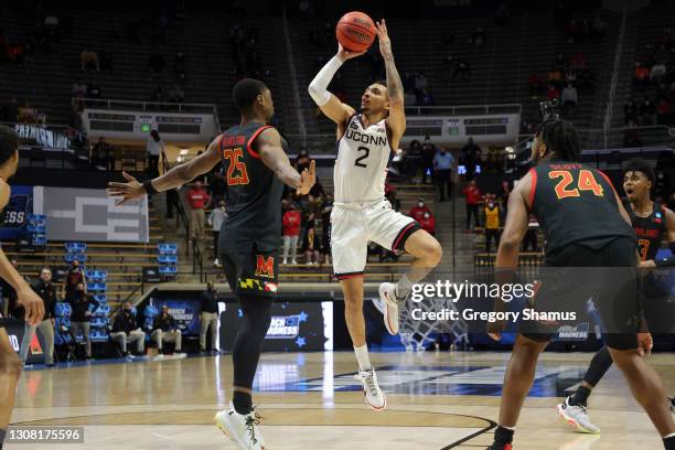 James Bouknight of the Connecticut Huskies shoots against Jairus Hamilton of the Maryland Terrapins during the second half in the first round game of...