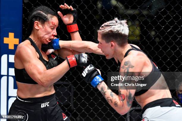 Macy Chiasson punches Marion Reneau in their bantamweight fight during the UFC Fight Night event at UFC APEX on March 20, 2021 in Las Vegas, Nevada.