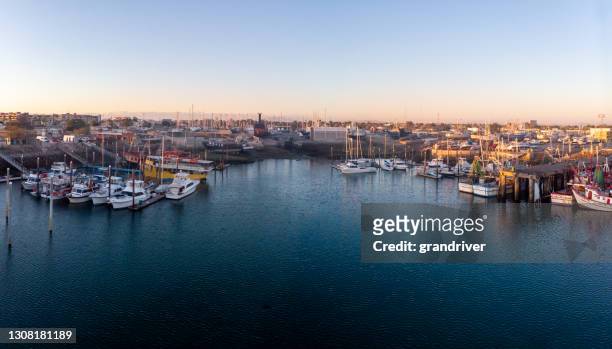marina with old shrimp trawler boats in the ocean side city of puerto penasco sonora, mexico at dusk - sonora mexico stock pictures, royalty-free photos & images