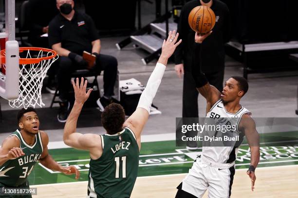 Lonnie Walker IV of the San Antonio Spurs attempts a shot while being guarded by Brook Lopez of the Milwaukee Bucks in the third quarter at the...