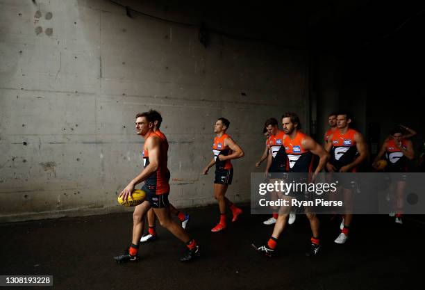 Stephen Coniglio of the Giants leads his team outnduring the round one AFL match between the GWS Giants and the St Kilda Saints at GIANTS Stadium on...