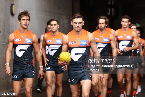 Stephen Coniglio of the Giants leads team mates out during the round one AFL match between the GWS Giants and the St Kilda Saints at GIANTS Stadium...
