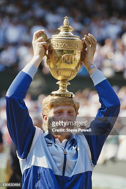 Boris Becker of Germany places the trophy on his head in to celebrate his defeat of Kevin Curren 6-3, 6-7 , 7-6 , 6-4 during the Men's Singles final...