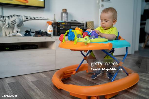 baby in baby walker - baby walker stock pictures, royalty-free photos & images