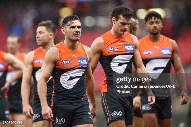 Stephen Coniglio of the Giants and team mates look dejected after losing the round one AFL match between the GWS Giants and the St Kilda Saints at...