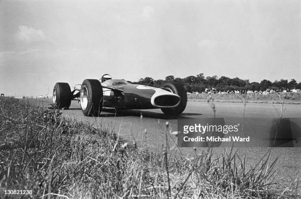 Scottish racing driver Jim Clark on his way to victory in a Lotus-Cosworth 49 during the British Grand Prix at Silverstone, 15th July 1967.