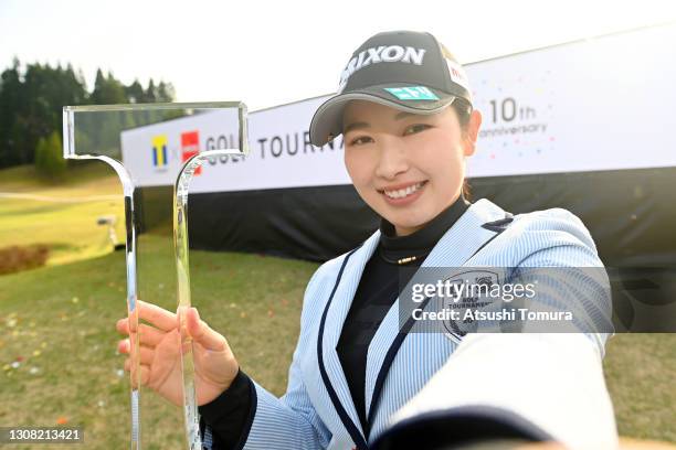 Sakura Koiwai of Japan imitates a selfie after winning the tournament following the final round of the T-point x ENEOS Golf Tournament at the...