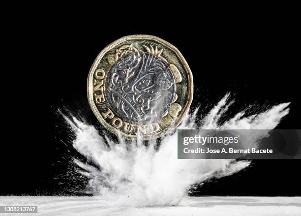 currency of pound sterling that falls down and produces an explosion. - exploding money stock pictures, royalty-free photos & images