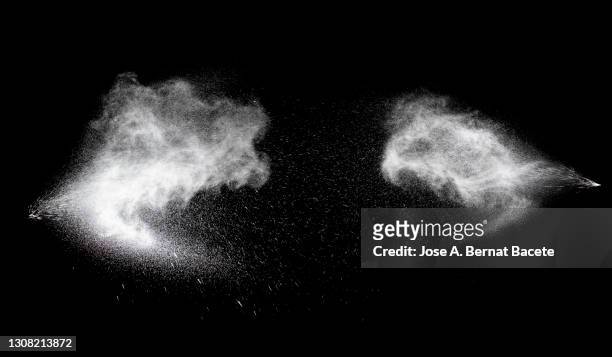 collision of two pressurized water jets on a black background. - spraydose stock-fotos und bilder