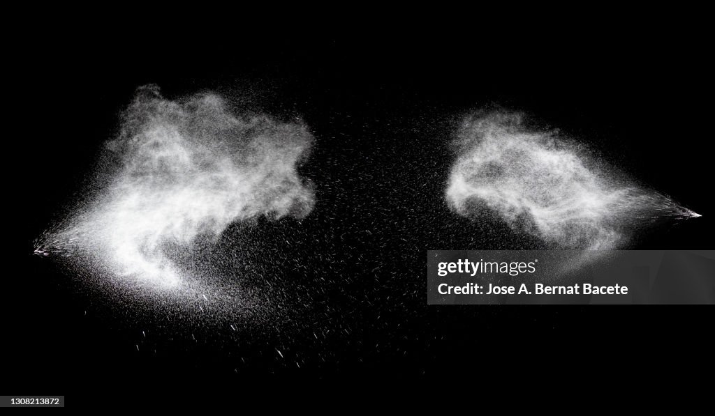 Collision of two pressurized water jets on a black background.