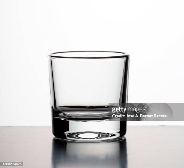 empty shot glass glass on a white background. - shot glass stock-fotos und bilder