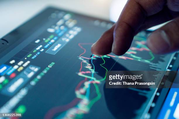 market analyze with digital monitor focus on tip of finger. - borsa foto e immagini stock