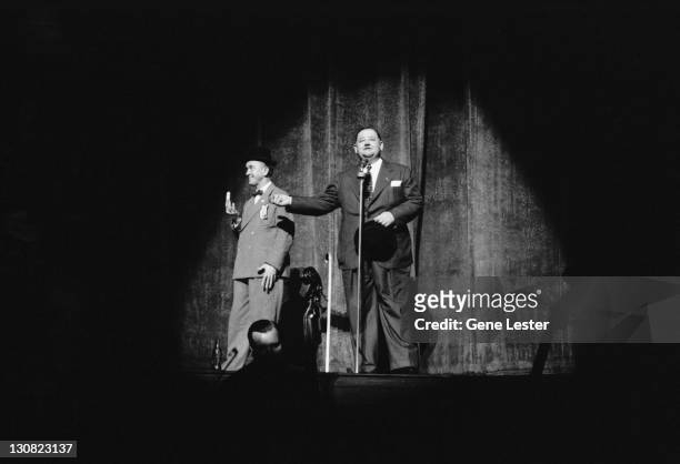 Comedy double act Stan Laurel and Oliver Hardy performing on stage in a Hollywood Victory Caravan show, USA, 16th May 1942. The Hollywood Victory...