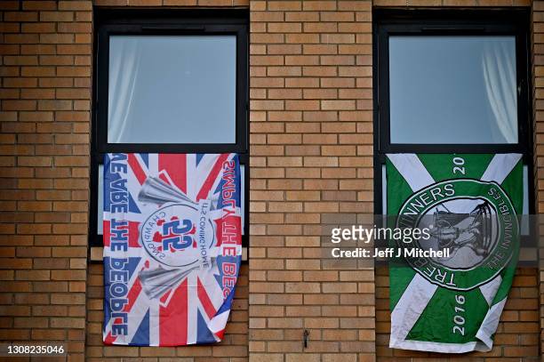 Flags are seen in a flat near Celtic Park football stadium as arch rivals Celtic and Rangers meet in the Old Firm derby fixture on March 21, 2021 in...