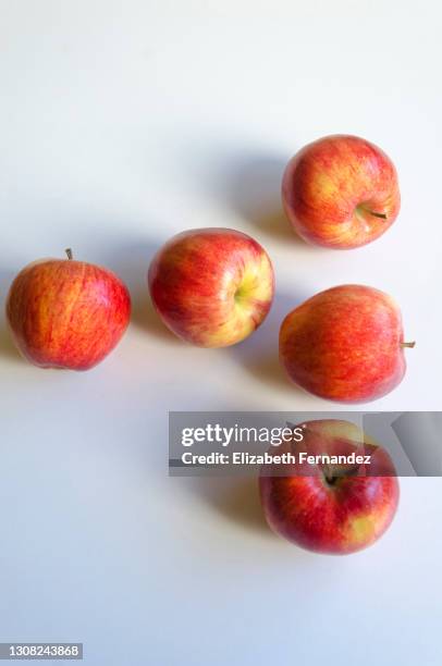 five red apples on white background, top view - apple white background stock-fotos und bilder