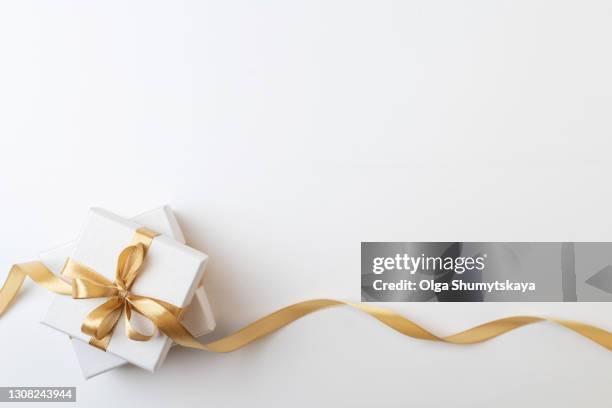 two white gift box with gold ribbon on white background - christmas ribbon foto e immagini stock