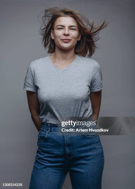 funny adult woman with flying hair in studio - white t shirt studio imagens e fotografias de stock