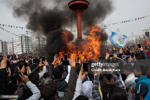 People watch the Newroz fire during Newroz festivities on March 21, 2021 in Diyarbakir, Turkey. Newroz is the Kurdish celebration of Nowruz, the...