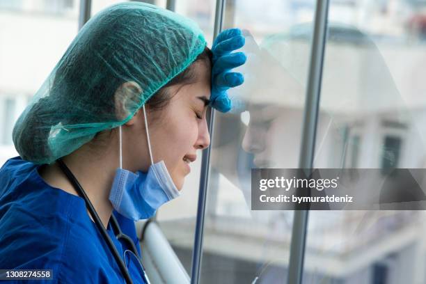 young healthcare worker crying - crying portrait stock pictures, royalty-free photos & images