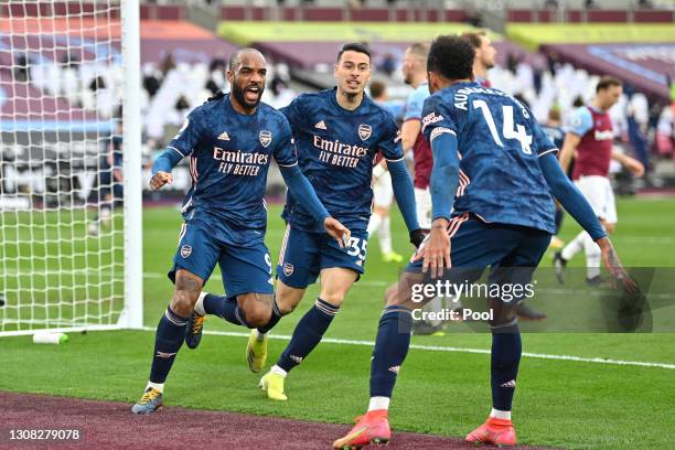 Alexandre Lacazette of Arsenal celebrates with Gabriel Martinelli and Pierre Emerick Aubameyang after scoring their side's third goal during the...