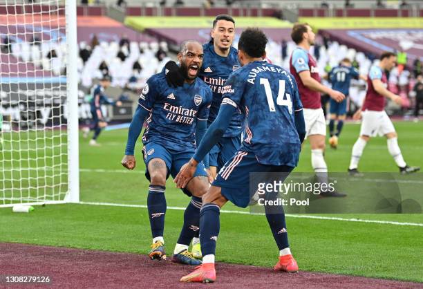 Alexandre Lacazette of Arsenal celebrates with Gabriel Martinelli and Pierre Emerick Aubameyang after scoring their side's third goal during the...