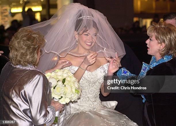 Mexican actress and singer Thalia has her veil adjusted before her marriage to Tommy Mattola December 2, 2000 in New York City.