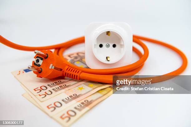 energy saving, plug, outlet and european notes - energie industrie stockfoto's en -beelden