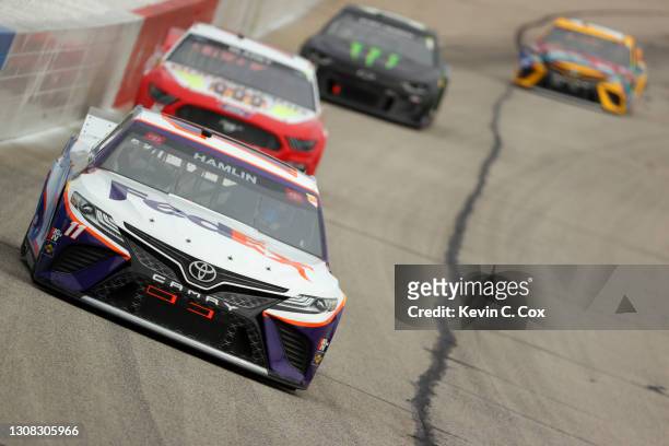 Denny Hamlin, driver of the FedEx Express Toyota, leads the field during the NASCAR Cup Series Folds of Honor QuikTrip 500 at Atlanta Motor Speedway...