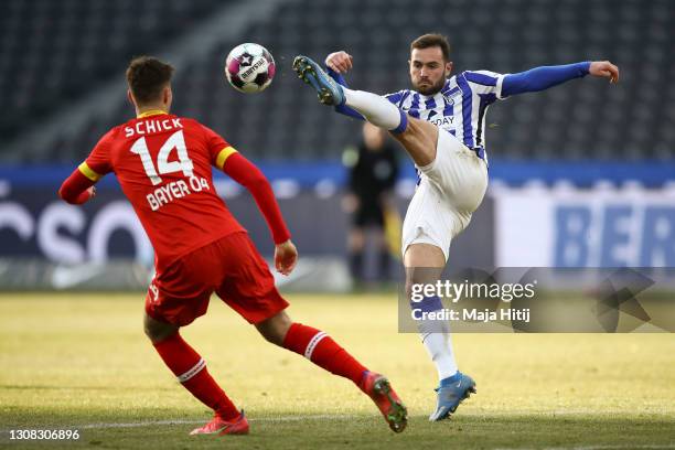 Lucas Tousart of Hertha Berlin kicks the ball next to Patrik Schick of Bayer Leverkusen during the Bundesliga match between Hertha BSC and Bayer 04...