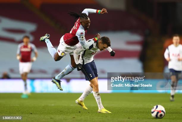 Sergio Reguilon of Tottenham Hotspur is challenged by Bertrand Traore of Aston Villa during the Premier League match between Aston Villa and...