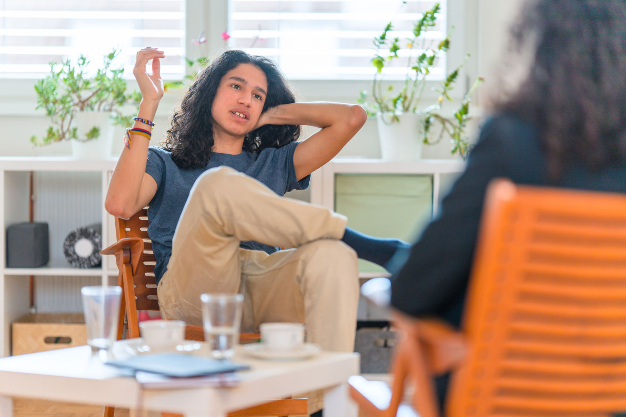 Young Hispanic Male Patient Listening To Female Psychotherapist in her Office Young Hispanic Male Patient Listening To Female Psychotherapist in her Office