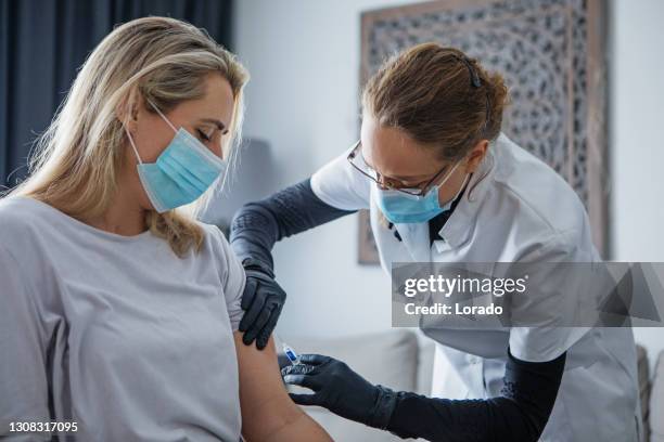 home administered covid-19 vaccination - administered stock pictures, royalty-free photos & images