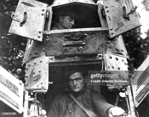 With its hatches open, an American skipper and gunner are visible sitting in close quarters inside a whippet tank, northwest of Verdun, France, 1918....