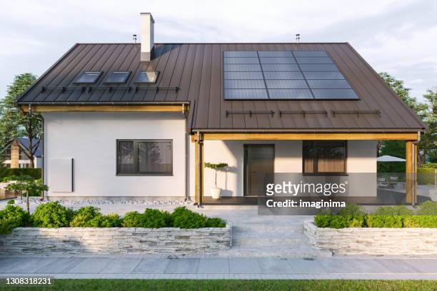 modern house with solar panels and wall battery for energy storage - modern house outside imagens e fotografias de stock